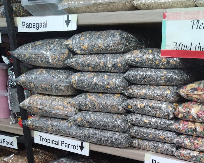 Feed bags full of sunflower seeds sold as “Parrot Food”. While sunflower seeds are acceptable as a snack, they can be deadly for a parrot if eaten in large quantities.