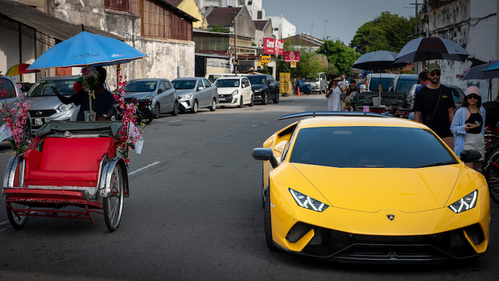 Sports car and rickshaw in Penang sports car in Penang