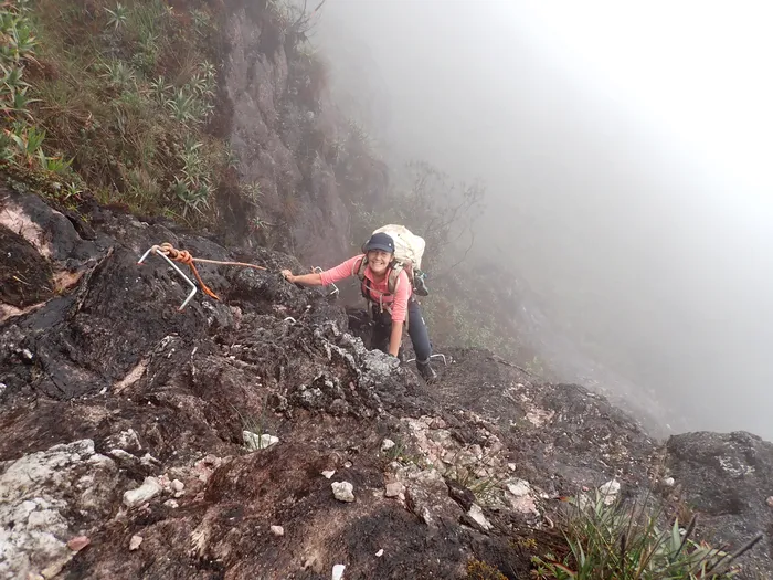 Climbing Up the side of the mountain using rope