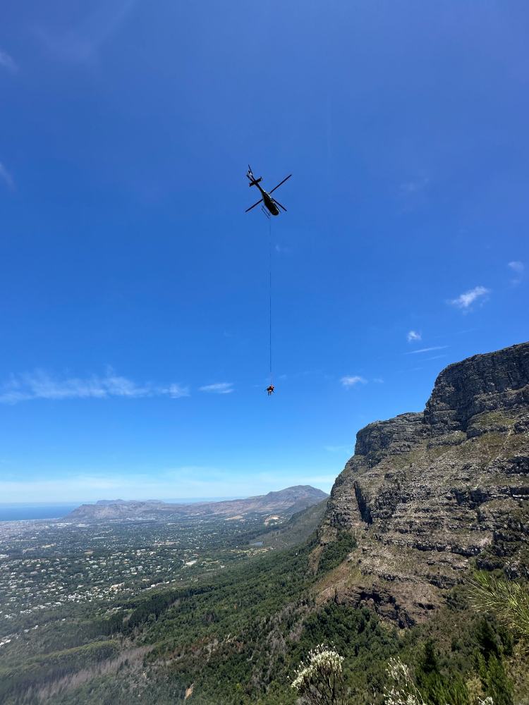 A team of helihackers being dropped in the mountains.