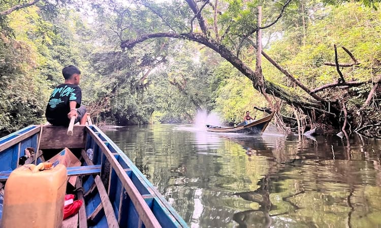 A local boat ride towards Bukit Raya