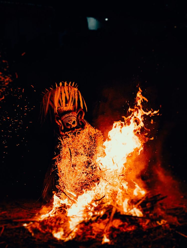 Humans using fire during a ritual.