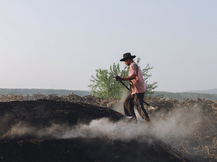 An individual walking on charcoal.